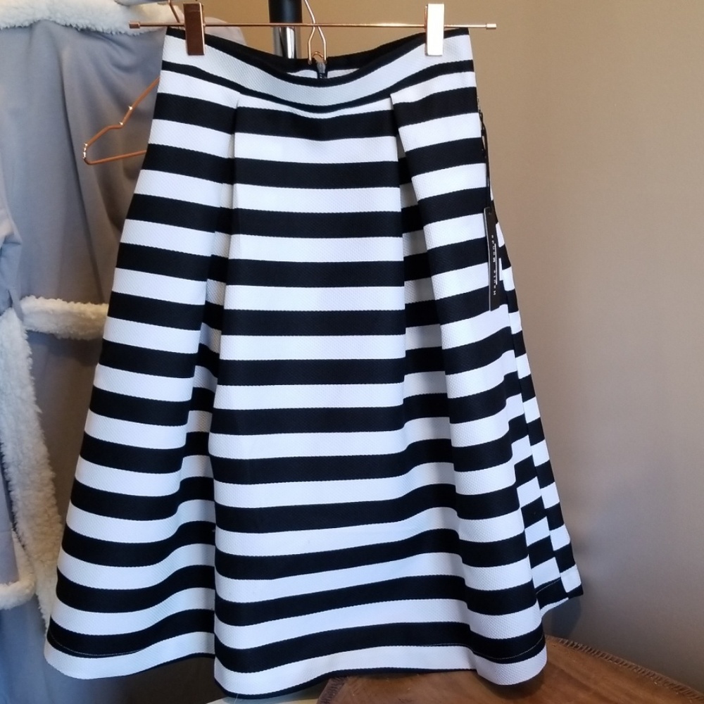 Skirt with black and white stripes.
